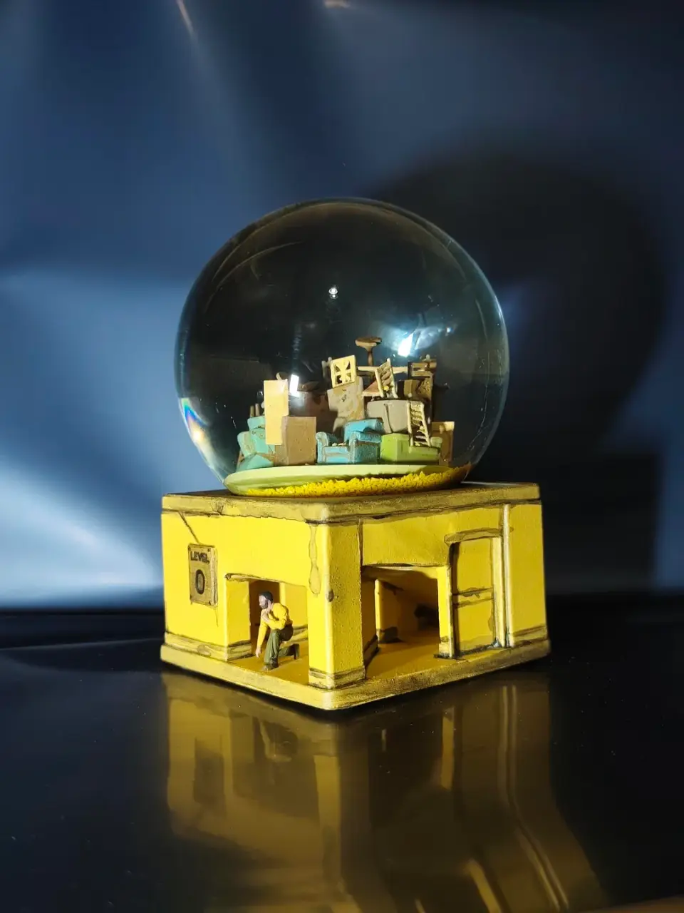 A small model of a building with a yellow base.