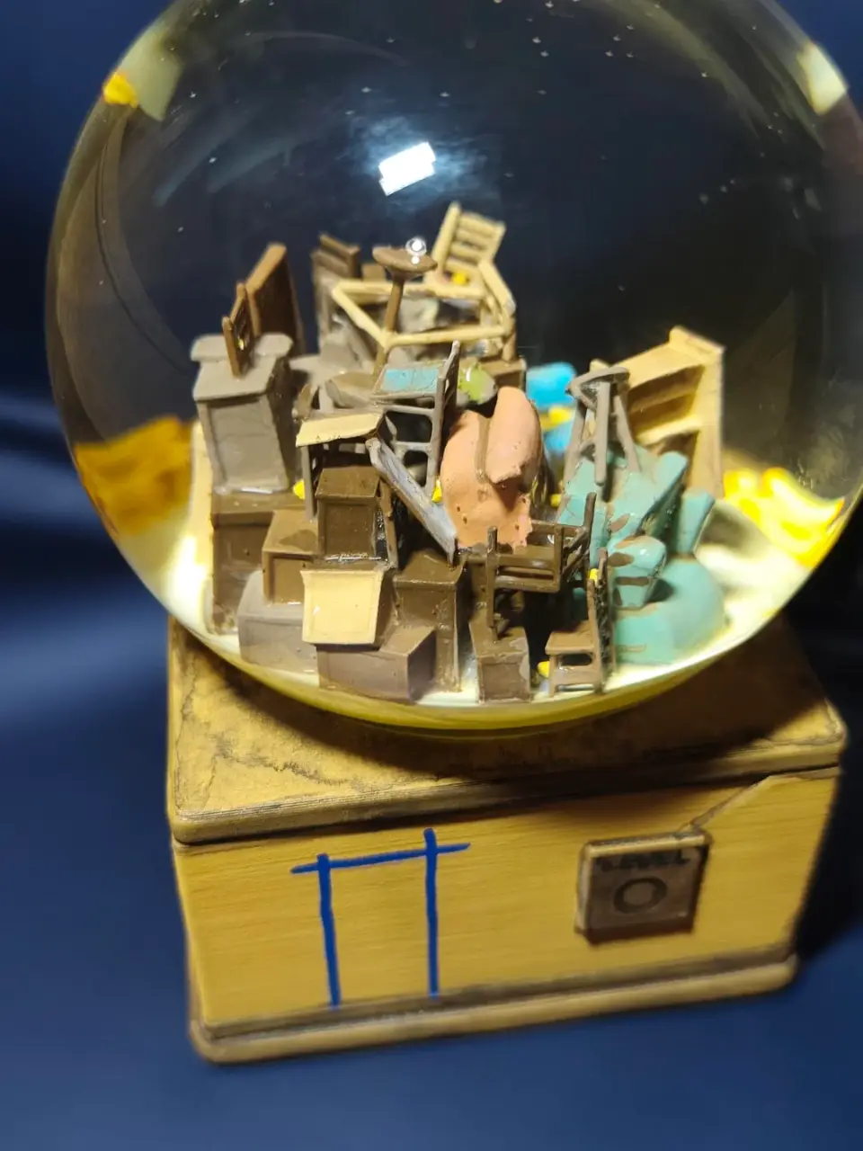 A small model of a building inside a glass ball.