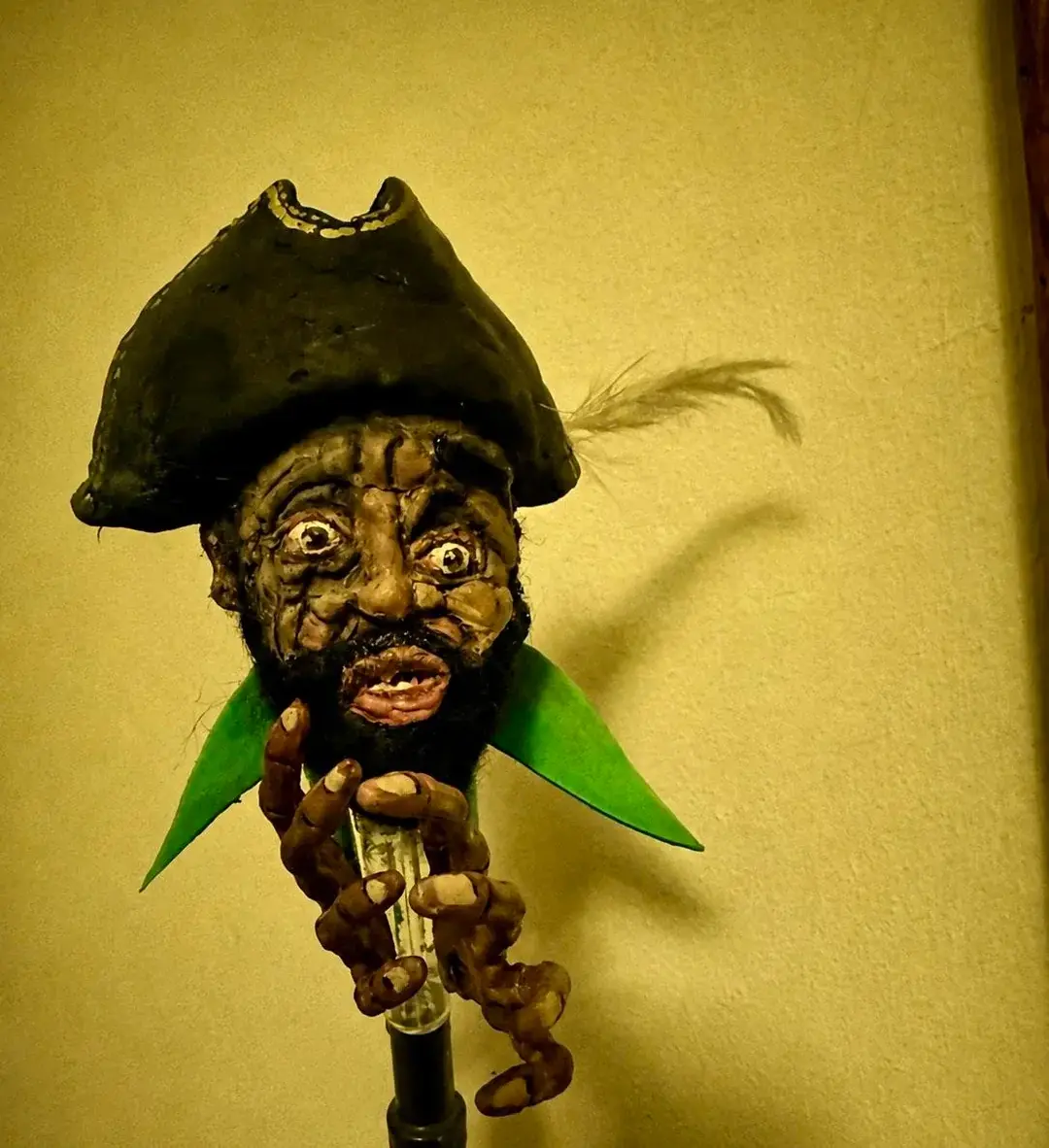 A creepy looking man with a pirate hat on.