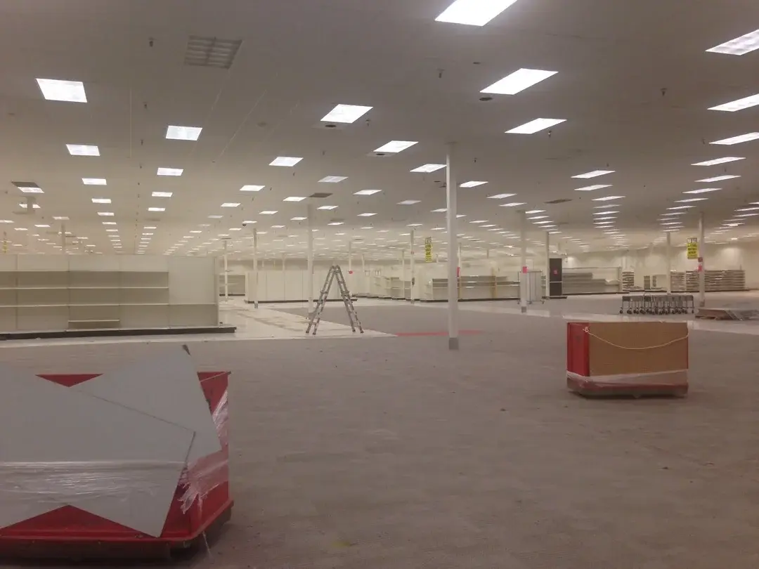 A large open room with a ladder in the middle.