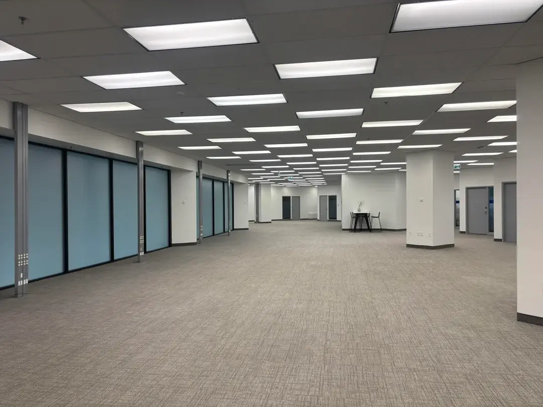 A large, empty room with white walls and ceiling.