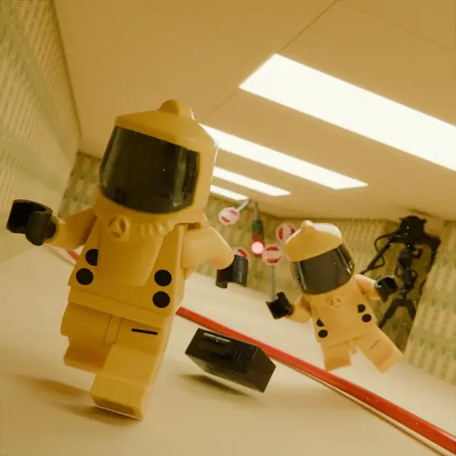 Two yellow figures in a room.