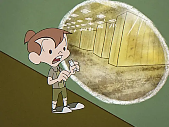 A boy holding a remote control in front of a mirror.