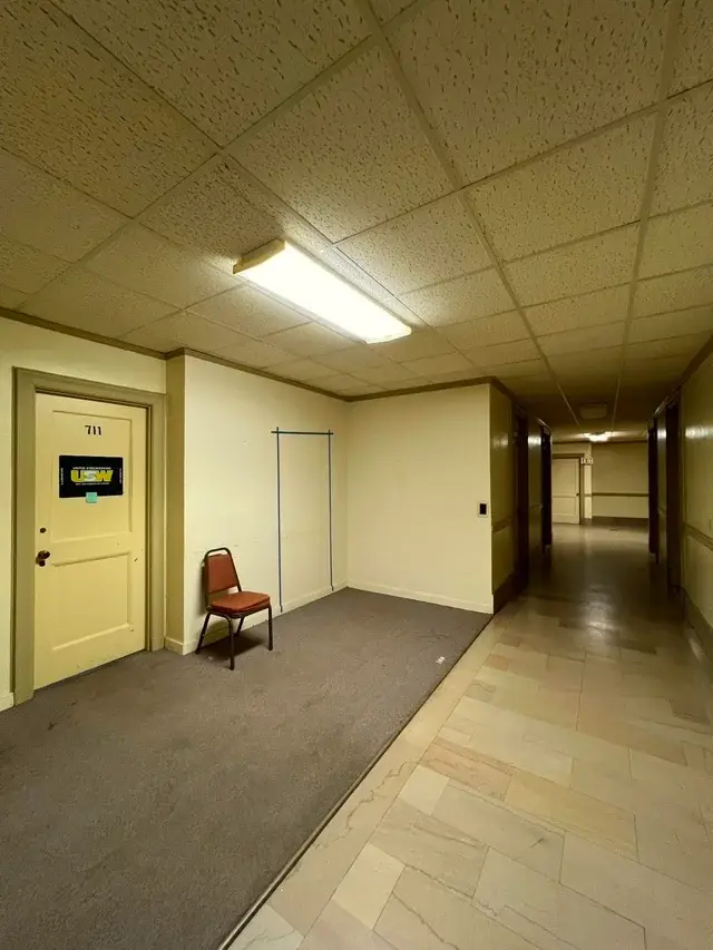 A chair is sitting in a hallway.